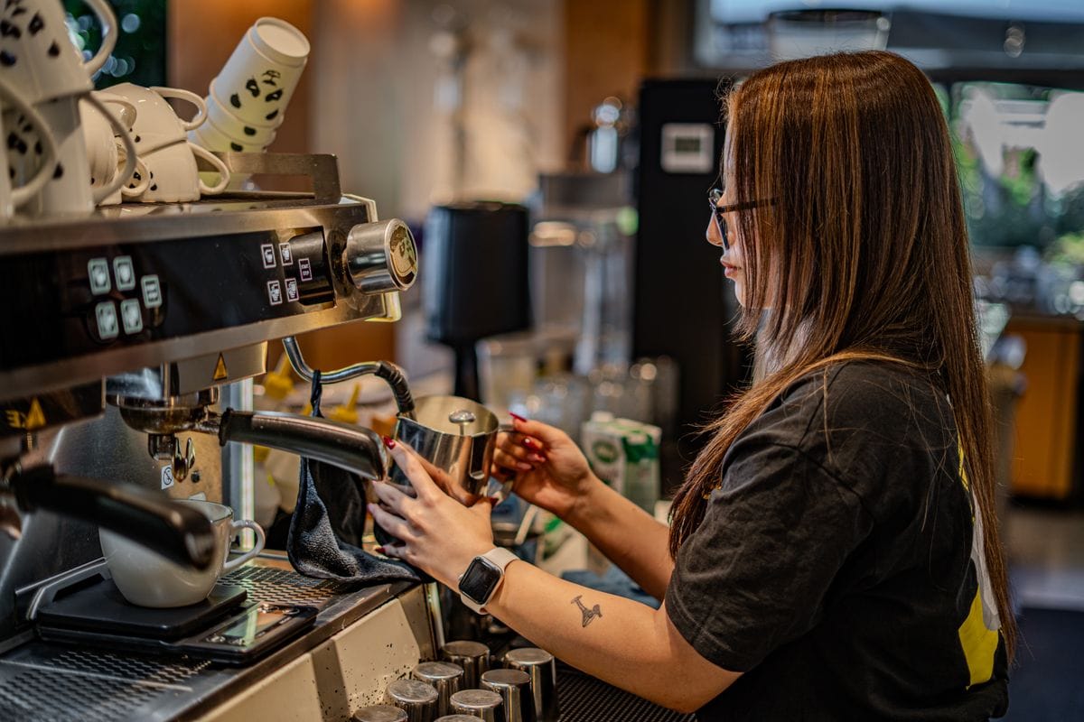 Barista working a commercial espresso machine