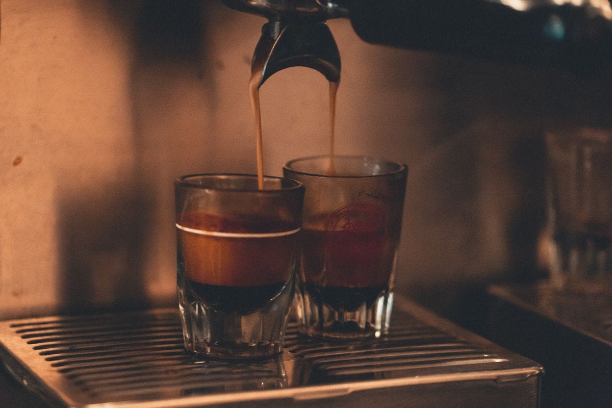 Espresso shots pulling into two glasses