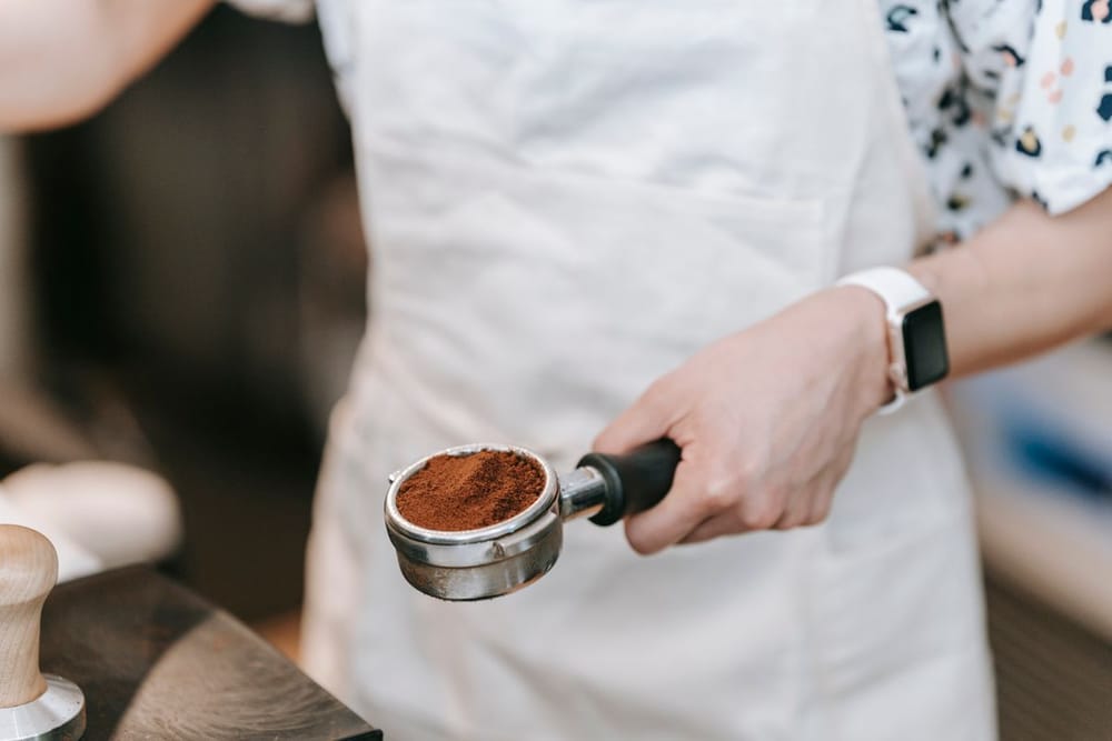 Barista tamping coffee in a portafilter